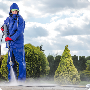 A person cleaning with pressure washing